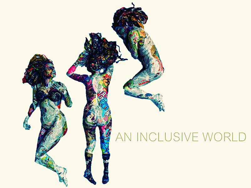 A cream text slide that reads “An Inclusive World” in green, san serif font. Paired with the text are three nude female figures. The figures have long, black hair and their bodies are made of collaged newsprint. Layered over their bodies and hair is bright, colorful paint and lettering.
