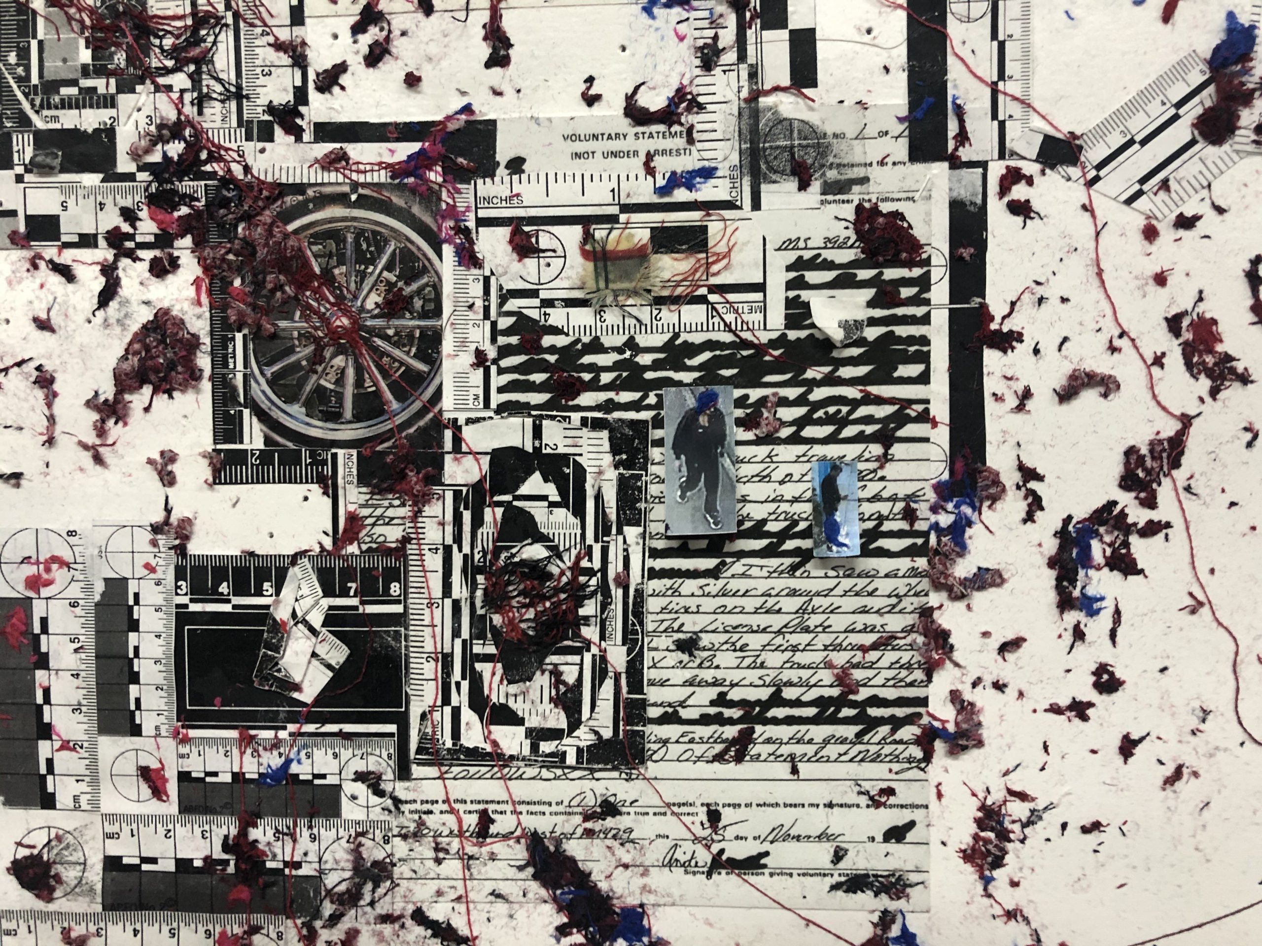 A close up of a collage with a busy composition. The background is white with a lot of material layered on top. The materials include a handwritten report in black ink, several forensic rulers in the metric system, tiny printed surveillance video stills, of a people walking, and separated red and blue fabric.
