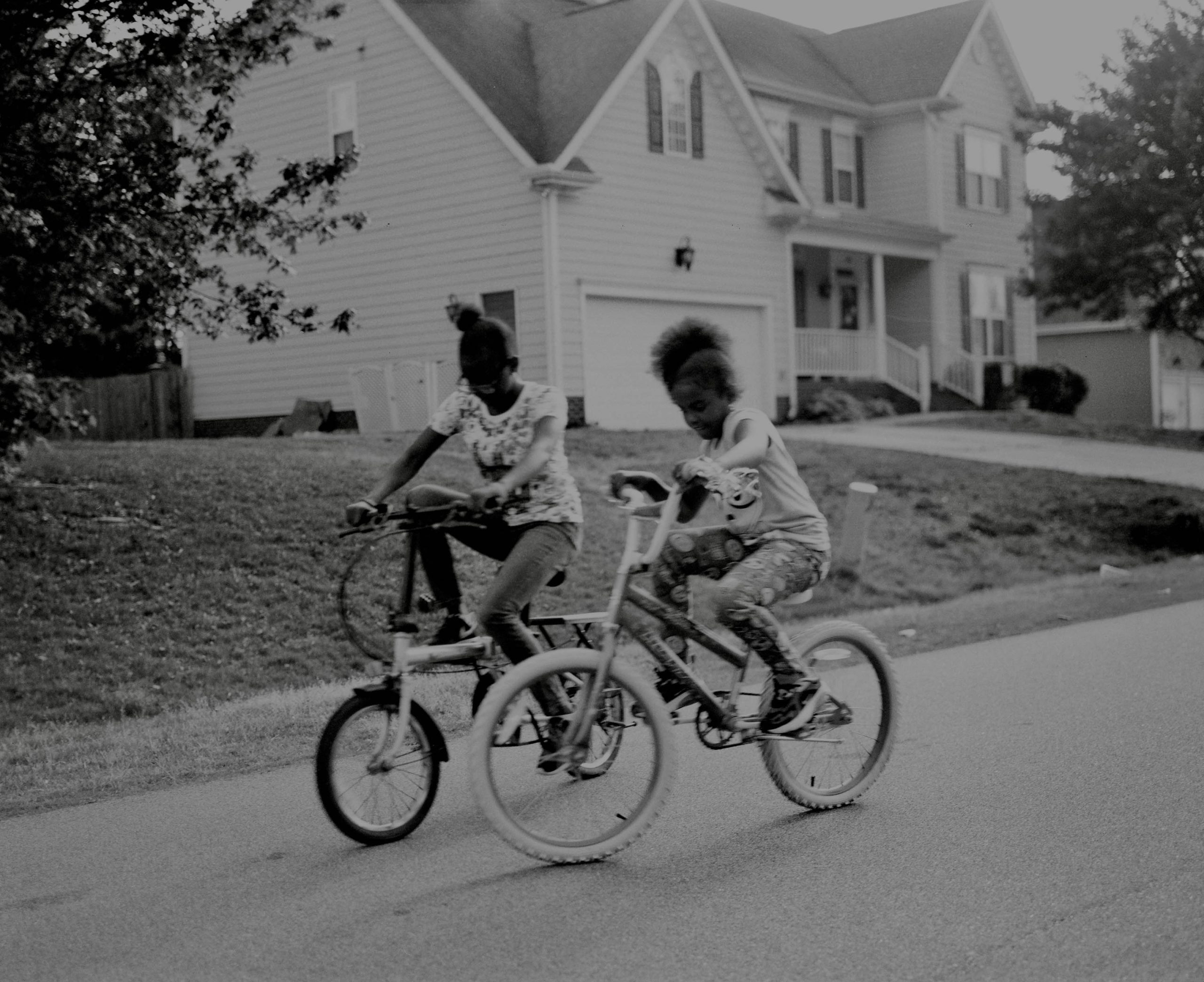 Nieces race down the neighborhood on their new bikes in Clayton, North Carolina.